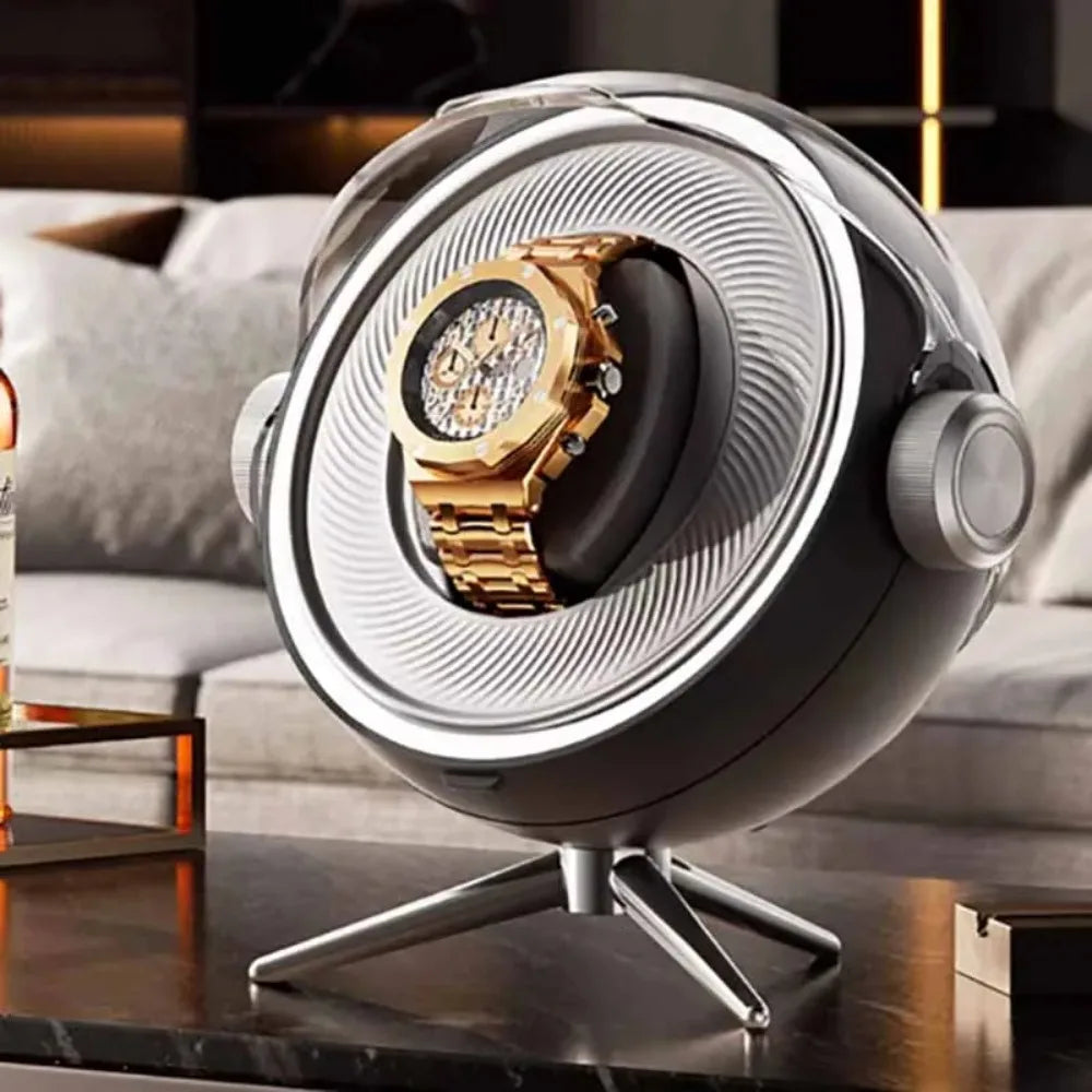 Luxury gold watch displayed in a modern, spherical watch winder on a living room table