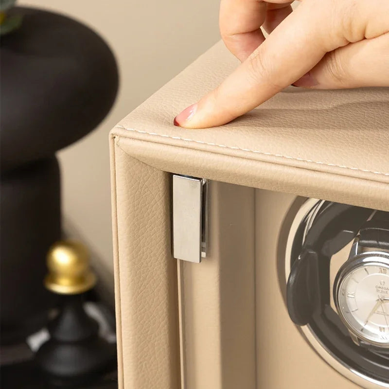 Hand closing beige leather watch winder case with silver latch and luxury watch inside