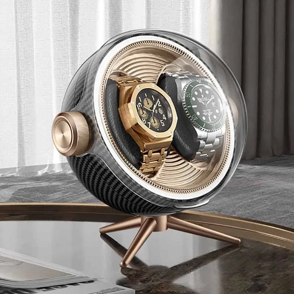 Luxury dual watch winder with gold and silver watches on a modern table, elegant setting